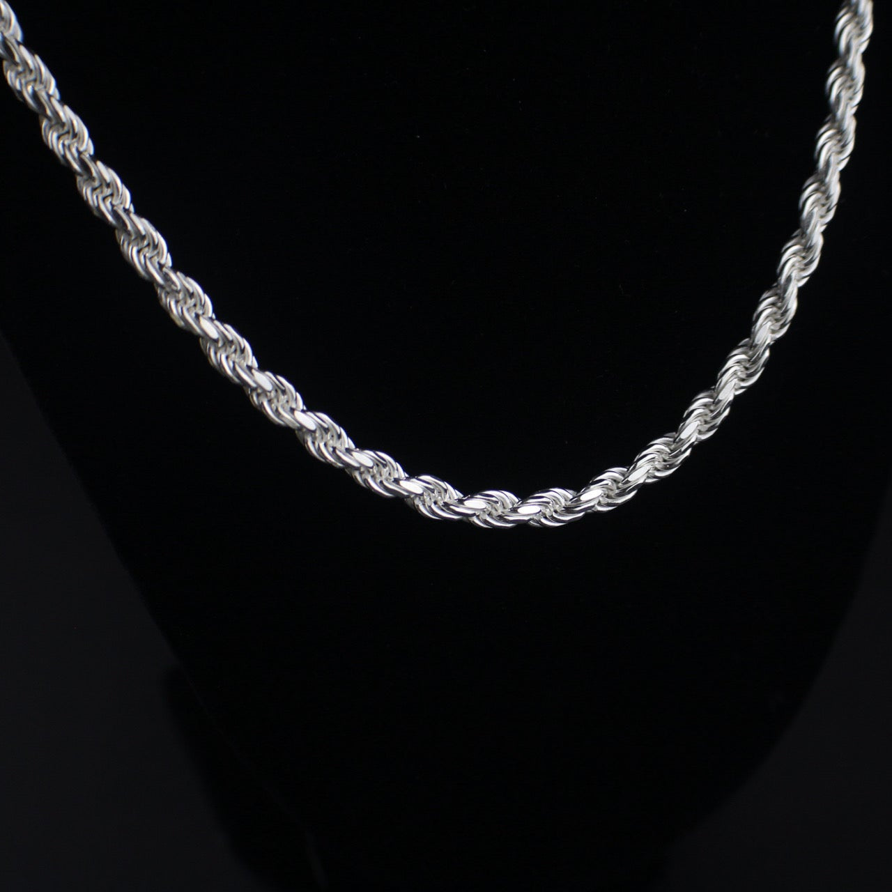 Silver rope chain on a black background