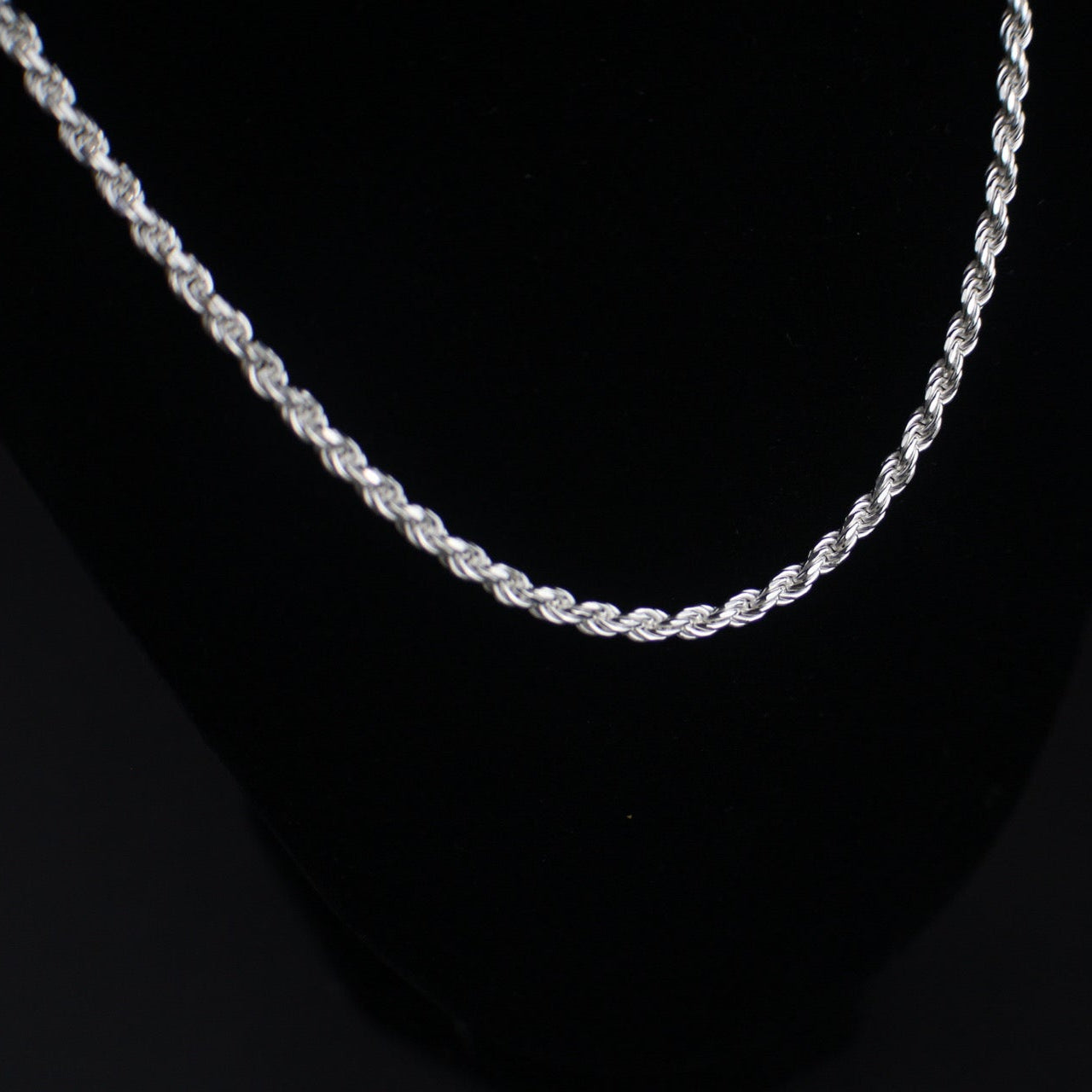 Silver rope chain on a black background