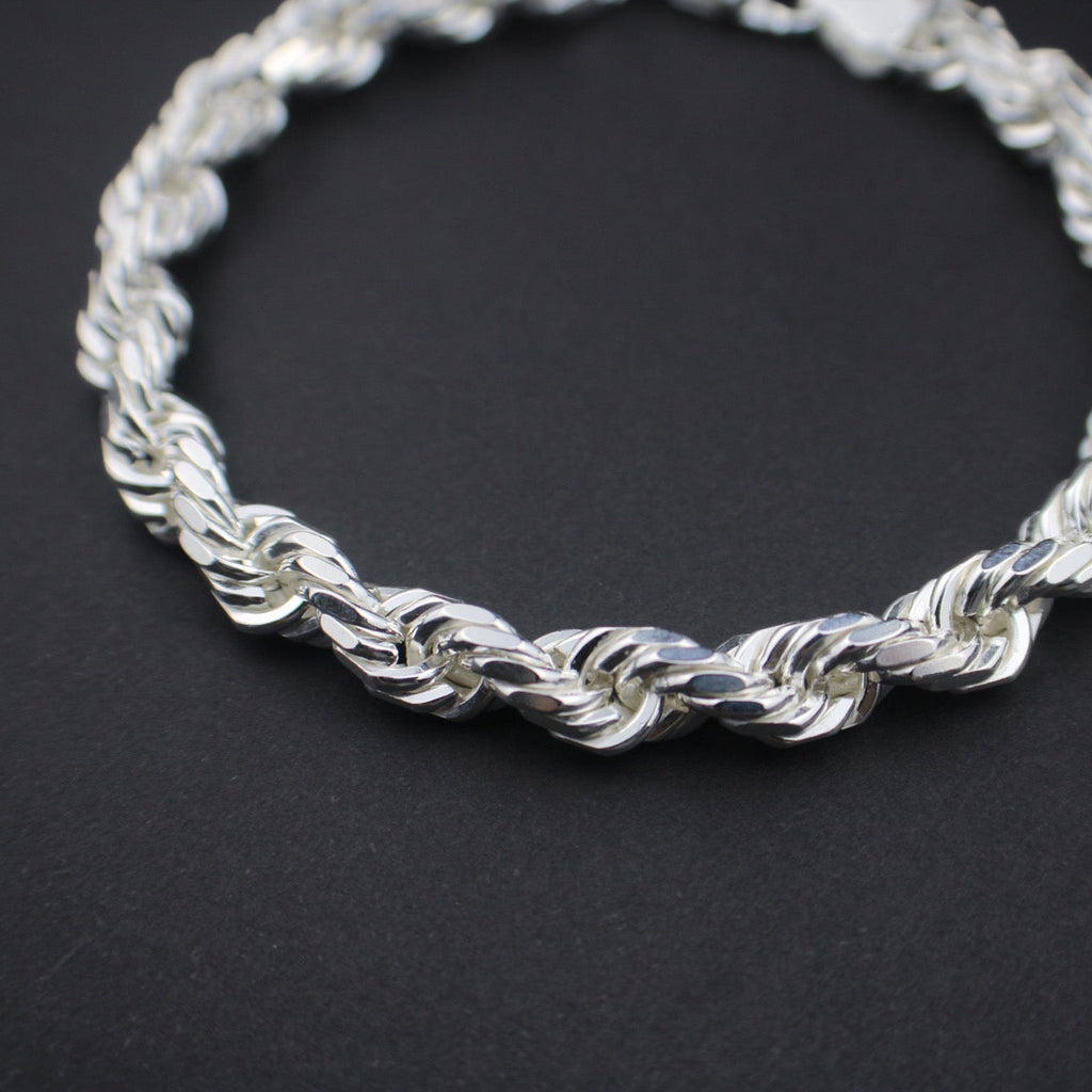 Silver braided bracelet on a black background