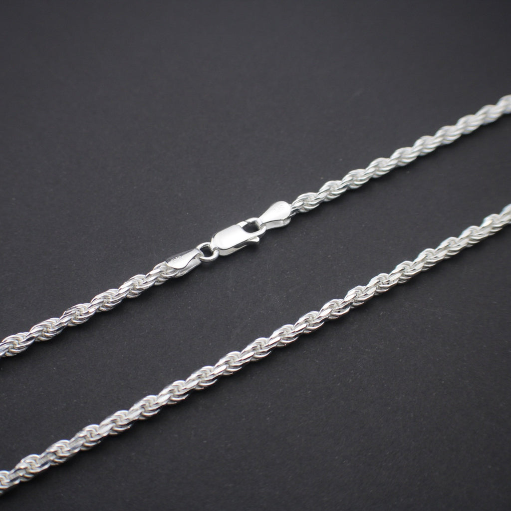 Silver rope chain on a dark gray background